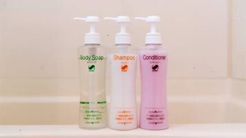 Three bottles of personal care products on a shelf.