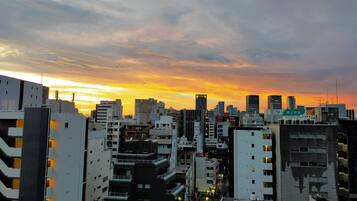 A dense urban skyline with high-rise buildings during sunset.
