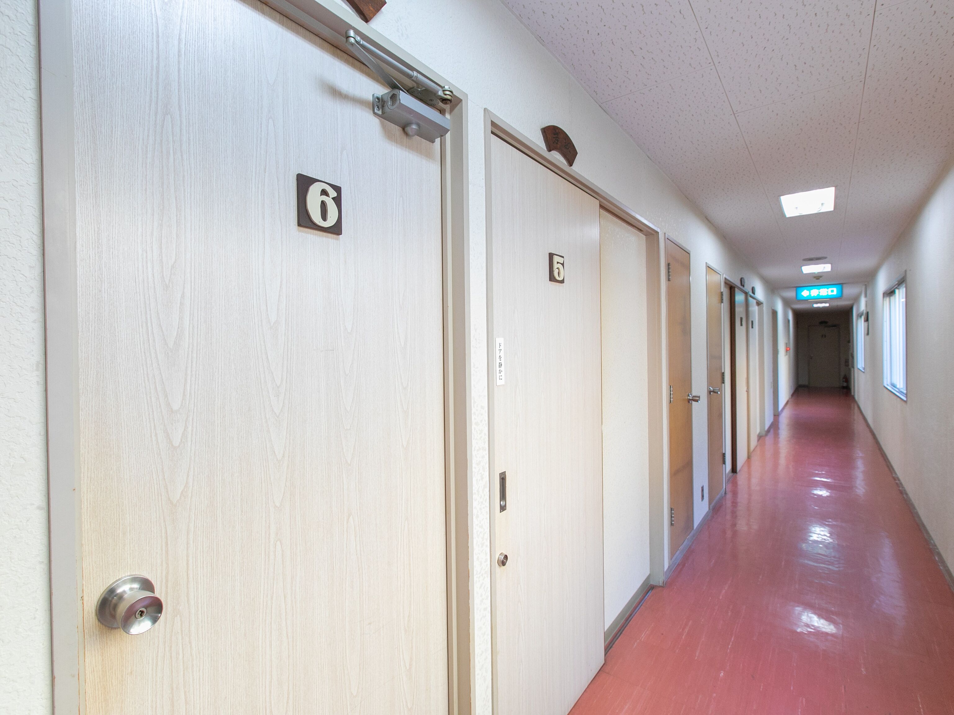 A corridor with doors numbered 5 and 6, leading to rooms.