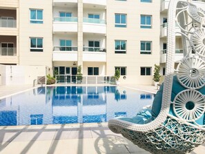 Outdoor pool - Beautiful and Bright 1BR Apartment in JVC (Dubai)
