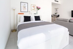 Laptop workspace, iron/ironing board, bed sheets