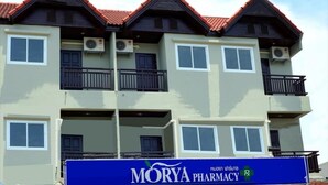 A multi-story building with balconies and air conditioning units. - My Living Place Samui (Koh Samui)