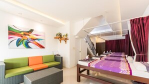 A modern hotel room with a large bed, a sofa, a coffee table, and a staircase. - Vacation Time House (Sa Khu)