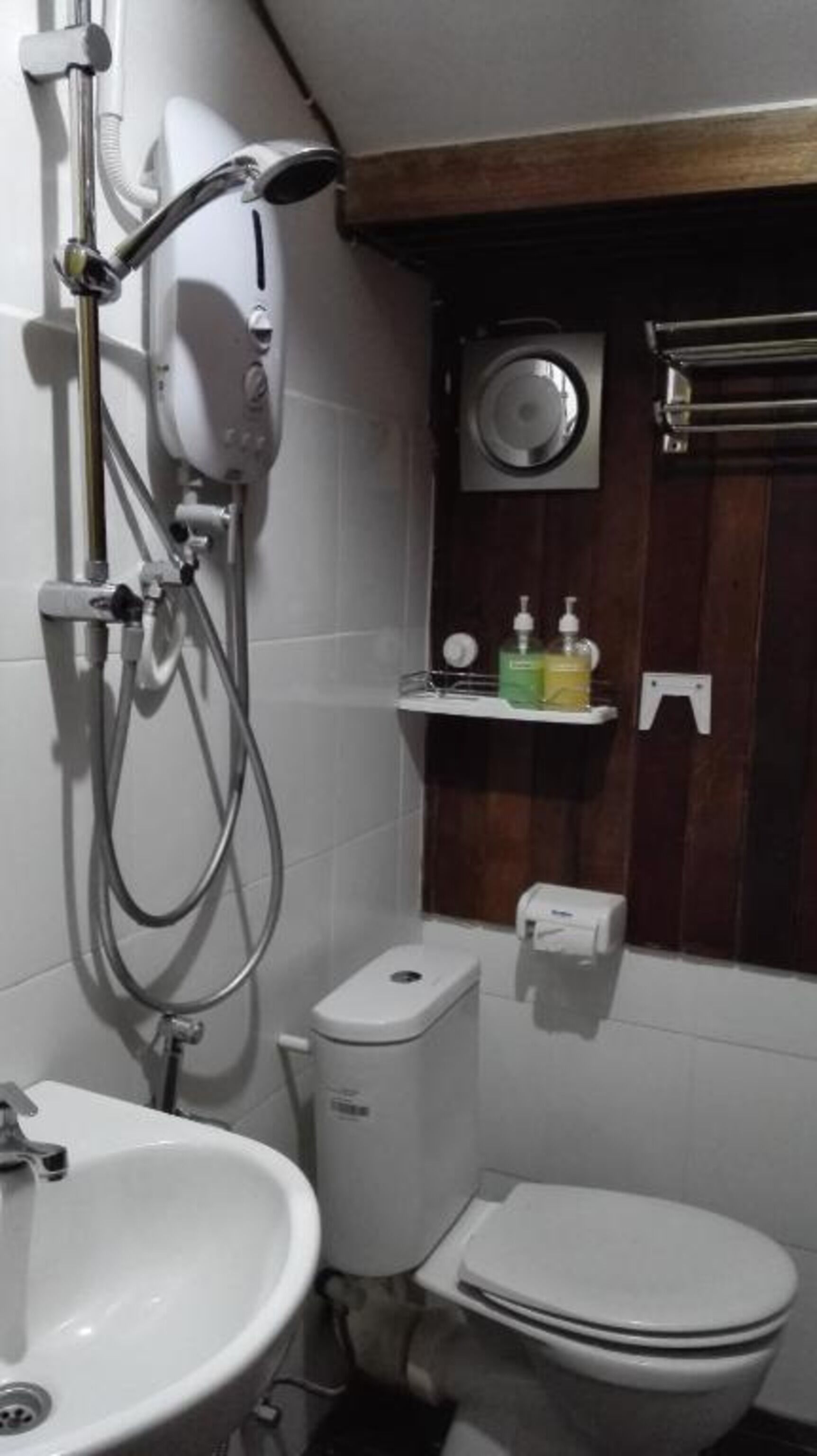 A bathroom with a shower, toilet, and sink.