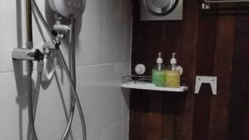 A bathroom with a shower, toilet, and sink.