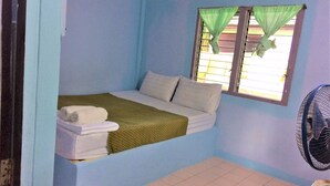 A small, single-bed room with a window and a fan. - AP Hotel (Ao Luek)