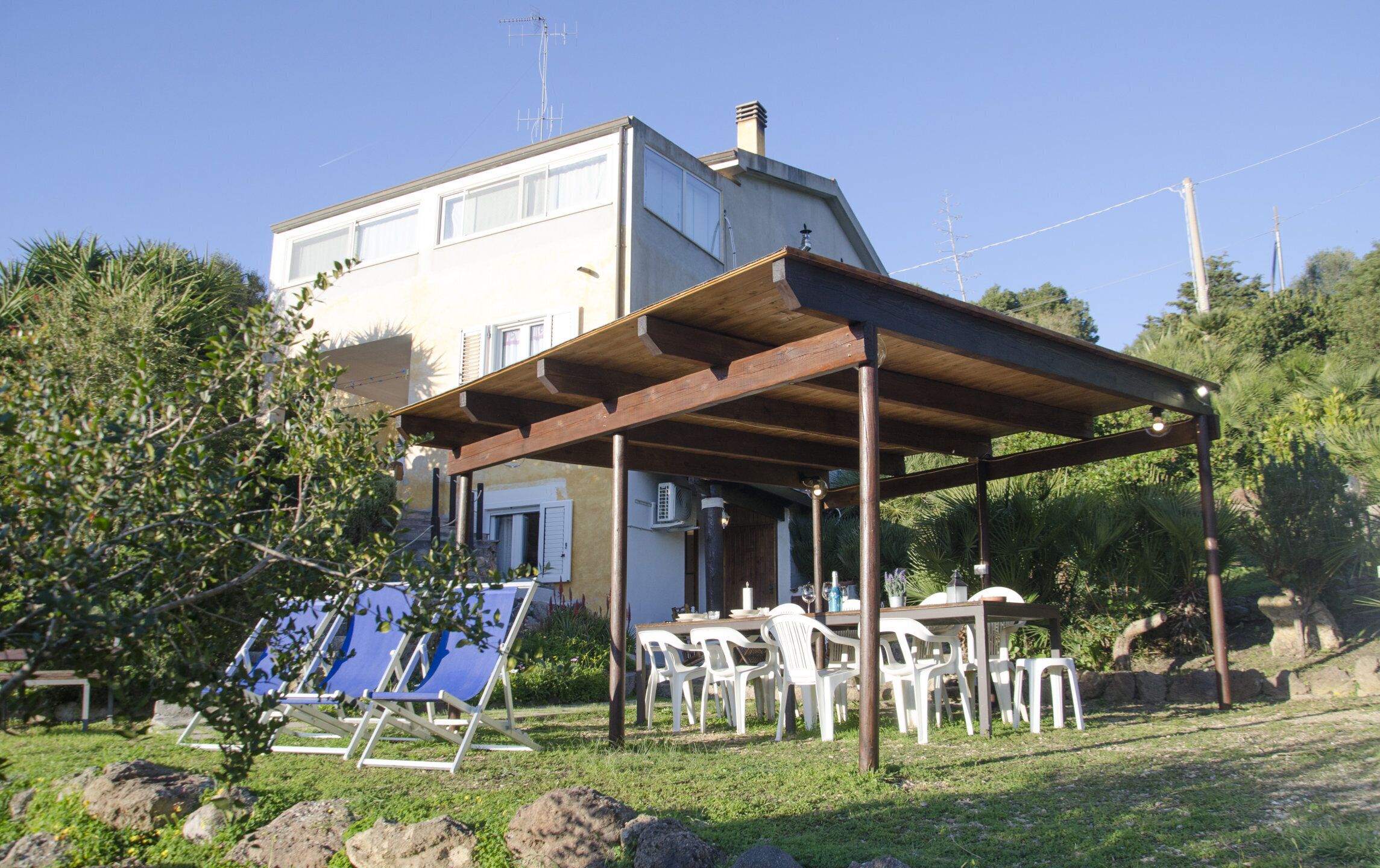 A two-story house with a covered patio area.
