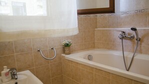 A bathroom with a sink, a bathtub, and a shower.