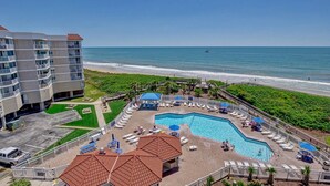A hotel with a swimming pool, beach view, and multiple balconies. - Top Floor Unit with amazing Views (North Topsail Beach)