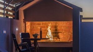 A brick fireplace with a table and chairs in front. - Holiday Home Near Zadar With Private Pool (Posedarje)