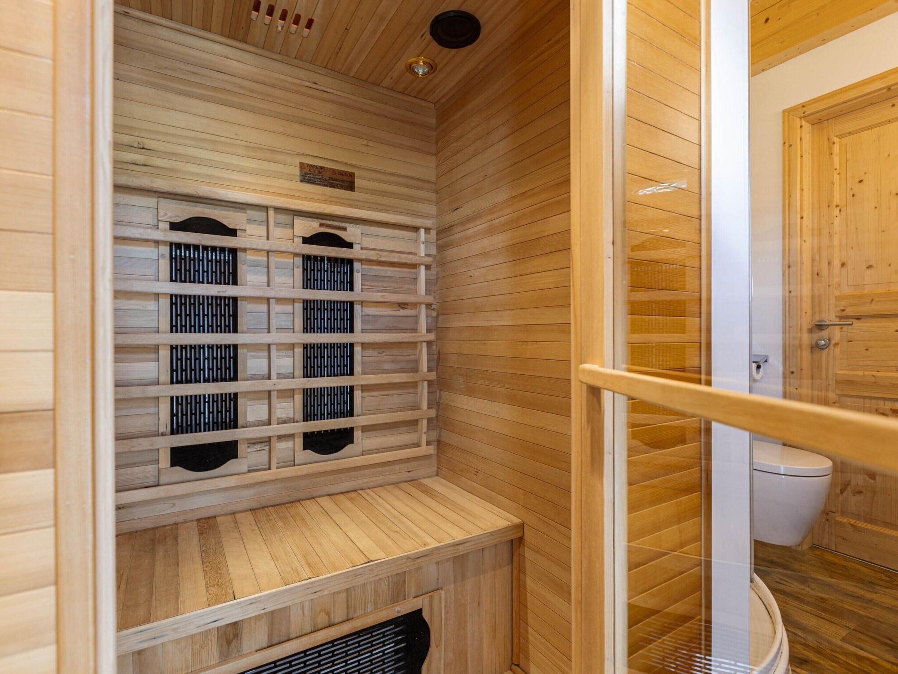 A sauna room with wooden walls and benches.