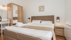 A neatly arranged bedroom with a large bed, bedside tables, a wardrobe, and a mirror. - Gorgeous Villa With Private Pool and Covered Terrace & Sea View (Kastelir-Labinci)