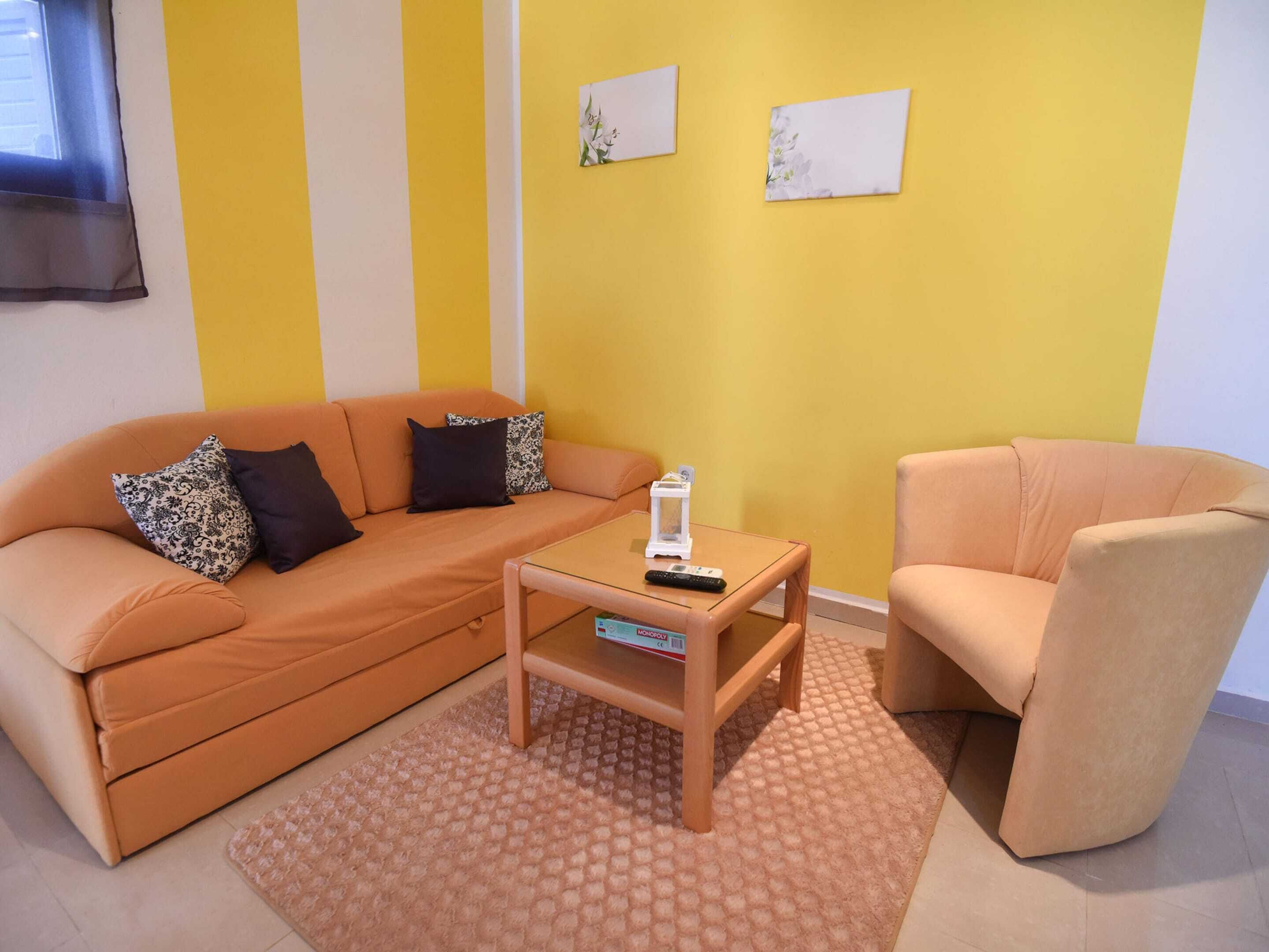 A living room with a sofa, a coffee table, and a chair.