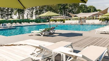 A poolside area with lounge chairs and umbrellas.