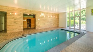 A swimming pool with a wooden interior, a sauna, and large windows. - Luxurious Mettet Mansion (Mettet)