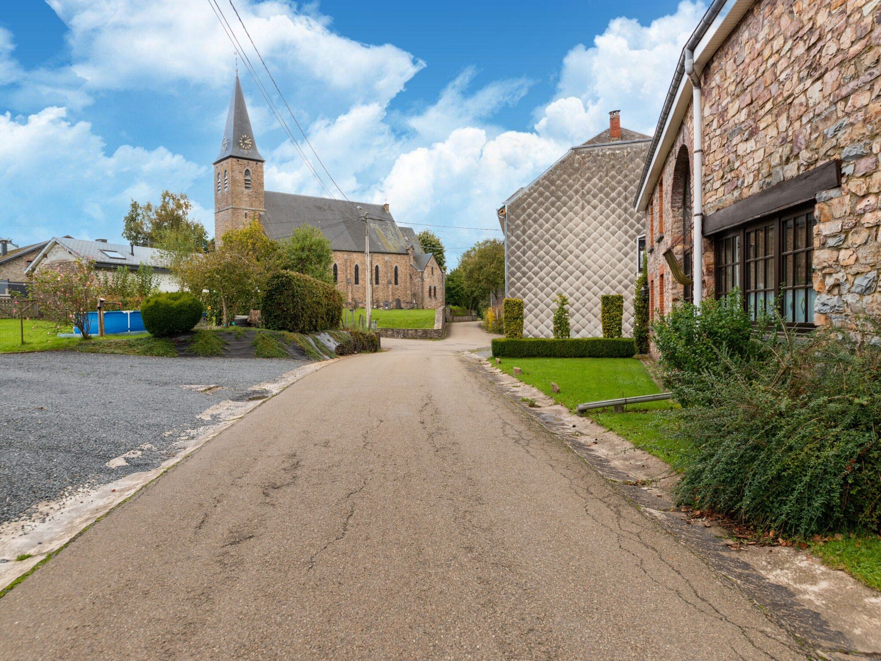 A rural street with a church and stone buildings.