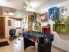 Relax in this spacious room with a foosball table, storage units, and a stroller-friendly entrance.