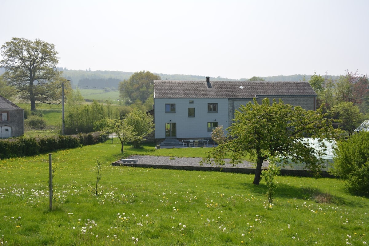 A two-story house with a garden in front.