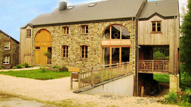 A stone building with a wooden door, windows, and a balcony. - Fort-like Holiday Home in Sart-bertrix, Near Luxembourg (Bertrix)
