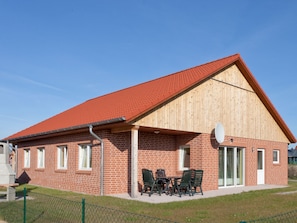 Guests can enjoy a communal patio area with a table and chairs, and satellite TV is available.