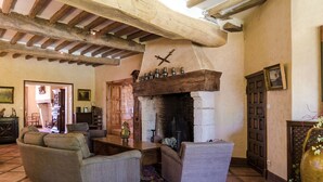 A rustic living room with a fireplace, wooden beams, and traditional furnishings. - Mansion in Sourzac With Private Pool (Sourzac)