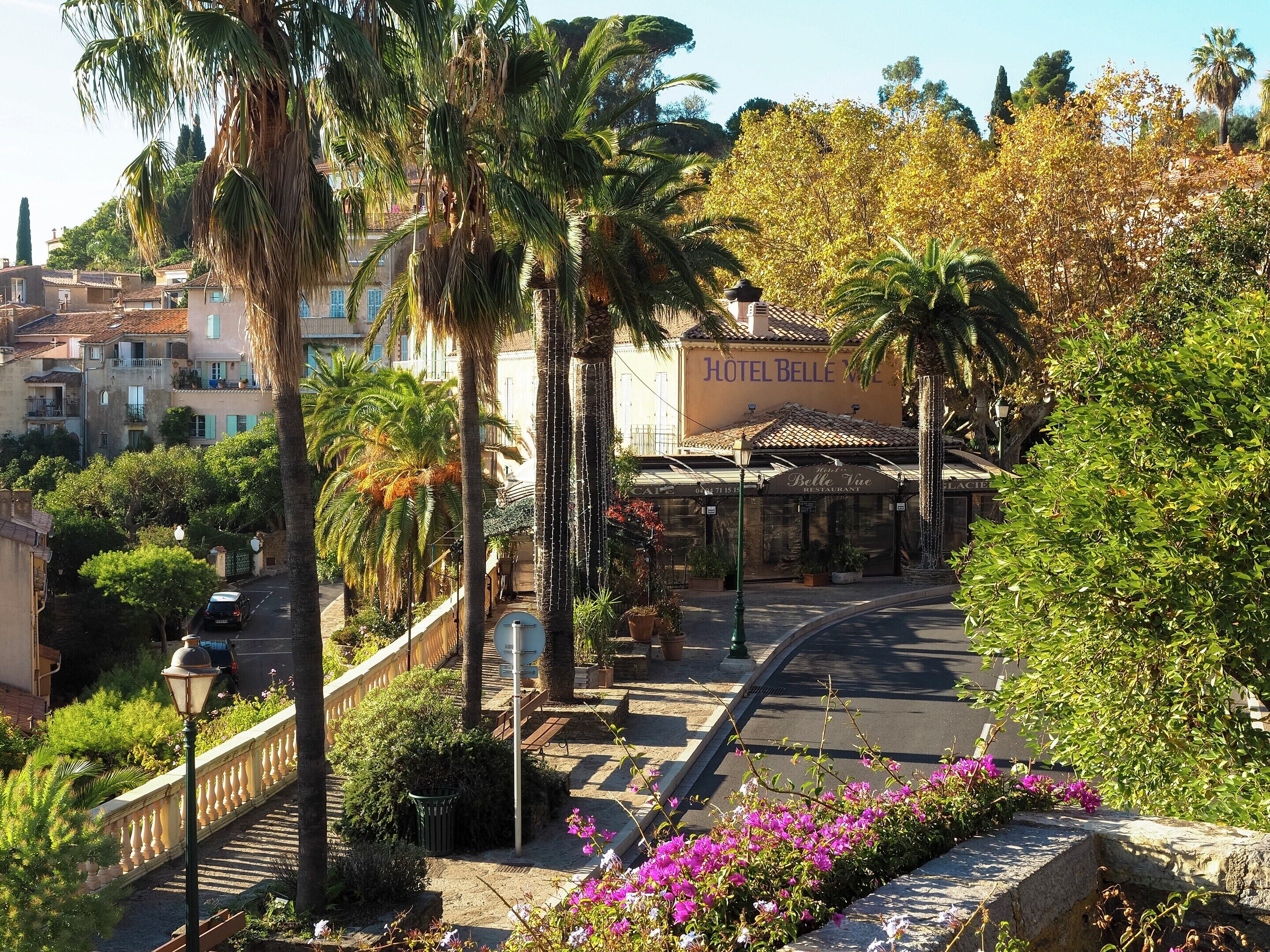 A street with a hotel named 'Hotel Belle Vie' and a restaurant named 'Belle Vie Restaurant' in the background.