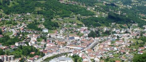 A town with a central square, surrounded by residential buildings and greenery.
