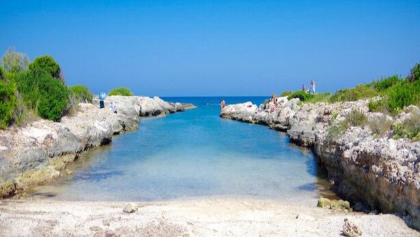 A coastal scene with rocky shores and clear blue water. - Cozy Holiday Home with Dishwasher near Zwolle (Dalfsen)