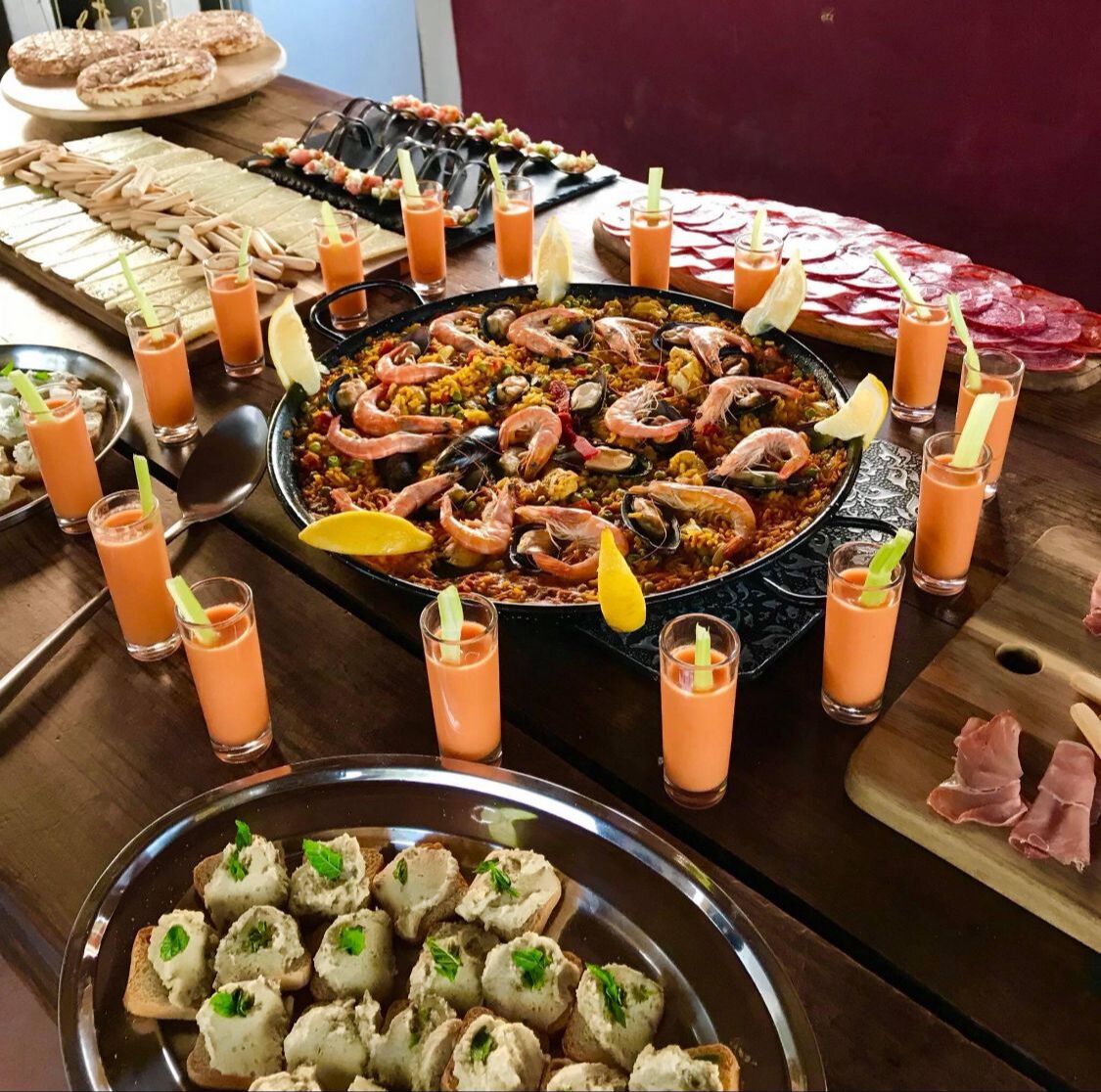 A seafood platter with shrimp, mussels, and other seafood, accompanied by drinks and bread.