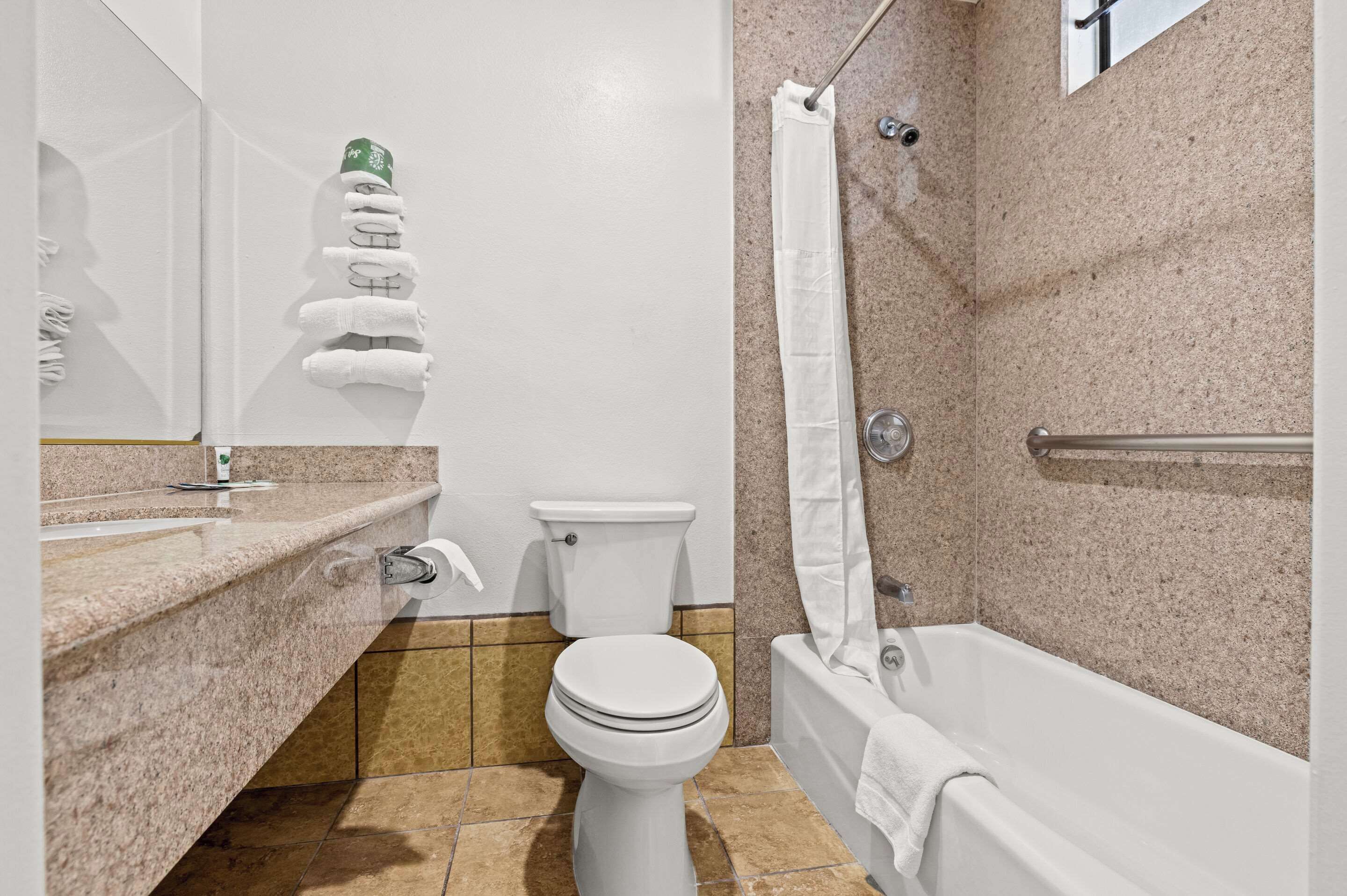 A bathroom with a toilet, sink, and bathtub.