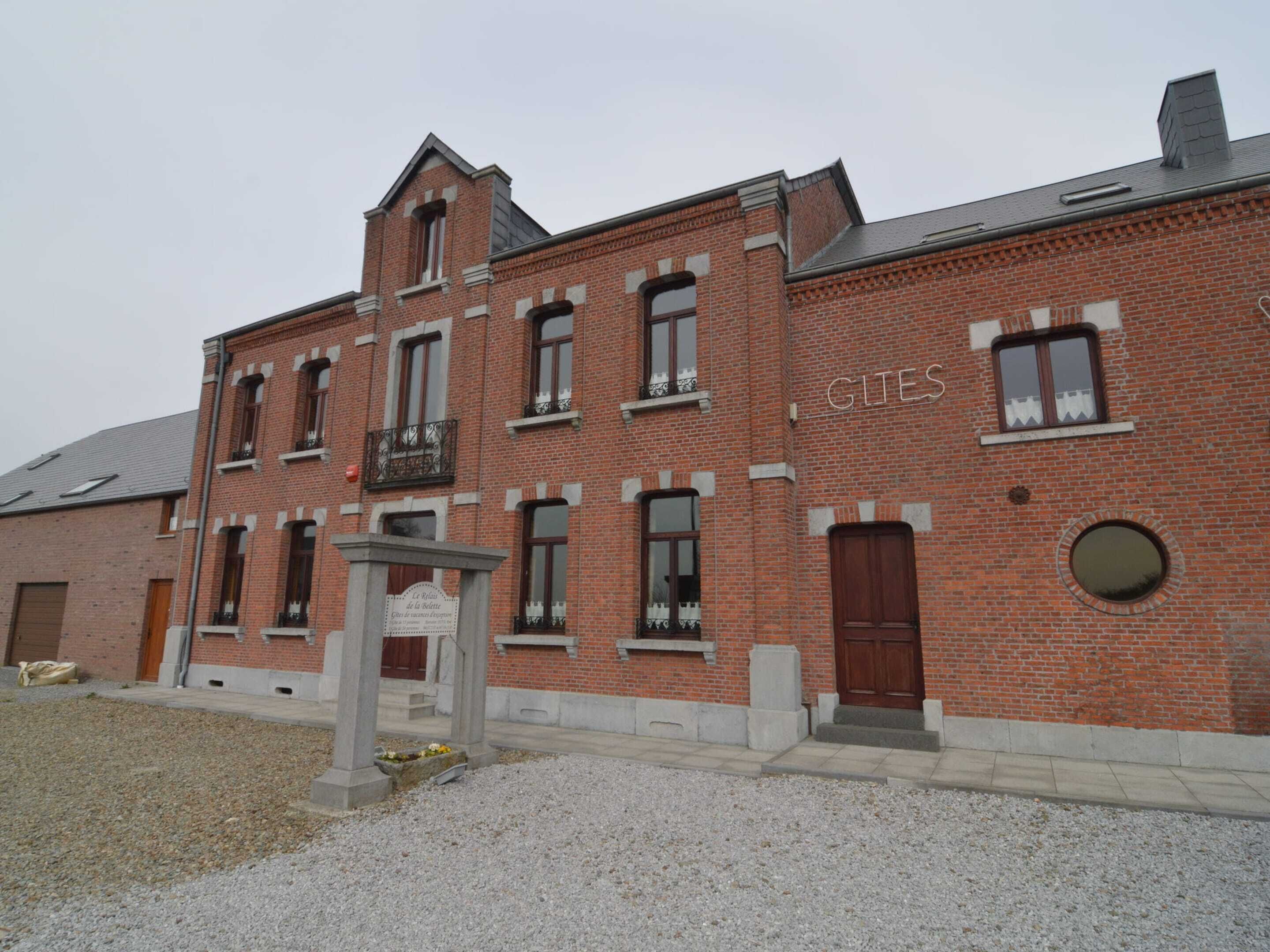 A red brick building with a sign reading "GLITES" and a stone entrance.