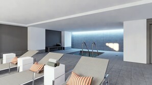 A modern indoor pool area with lounge chairs and a bench. - Walk to everything: Pike Place Penthouse, Seattle (Seattle)