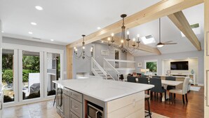 A spacious kitchen with a large island, wooden beams, and a chandelier. - Newly Renovated 3rd Row Palmetto Dunes home with pool on beach path! (Hilton Head Island)