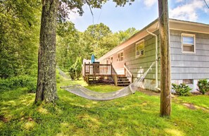 Enjoy a peaceful retreat in this serene single-story home surrounded by lush greenery and an outdoor space.