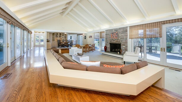 A spacious living room with a large L-shaped sectional sofa, a fireplace, and a dining area with a table and chairs. - Beautiful Napa Valley Home on Golf Course -  Perfect Wine Country Retreat (Napa)