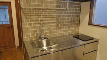 Family Apartment, Multiple Beds (401-402) | Private kitchen | Fridge, microwave, cookware/dishes/utensils, cleaning supplies