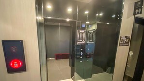 An elevator interior with a control panel, a red emergency button, and a digital display. - Hotel Live Max Okayama Kurashiki Station (Kurashiki)