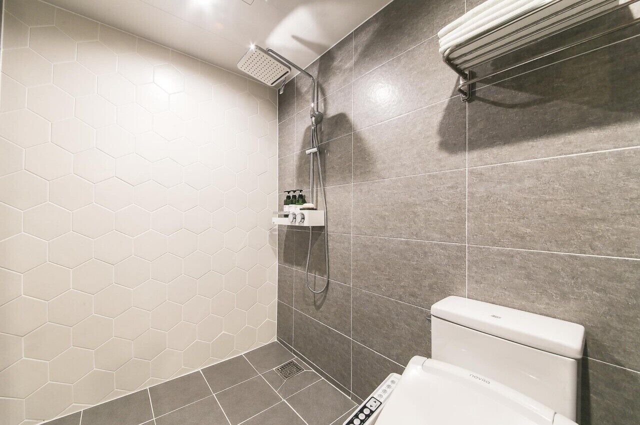 deluxe room | bathroom | rainfall showerhead, free toiletries, hair dryer, electronic bidet