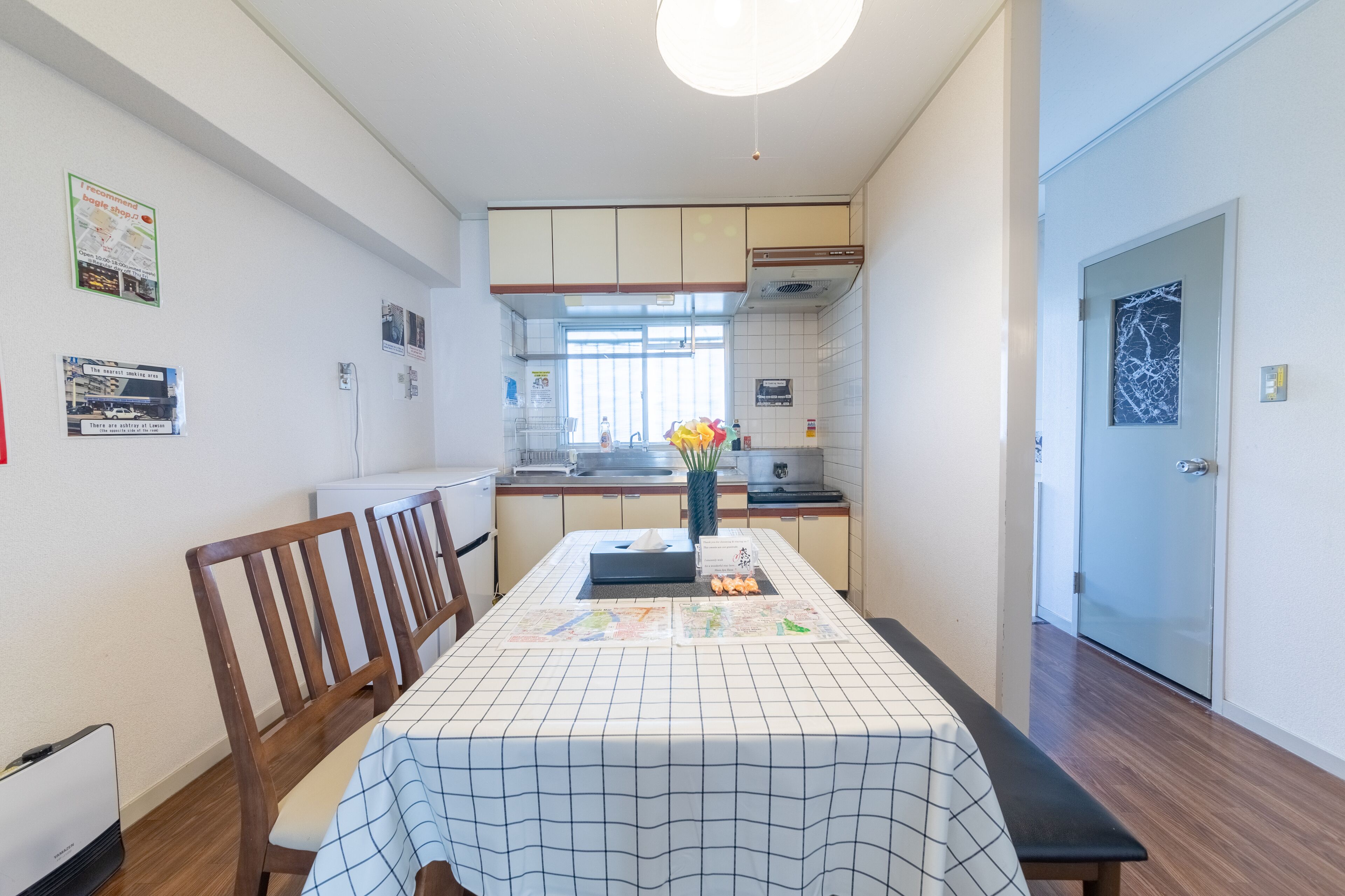 A modern kitchen with a dining table, chairs, and a view into the adjacent dining area.