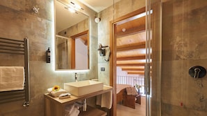 A modern bathroom with a large mirror, a wooden vanity, and a glass shower enclosure. - Casanova - Family Apartments Residence (San Quirico d'Orcia)