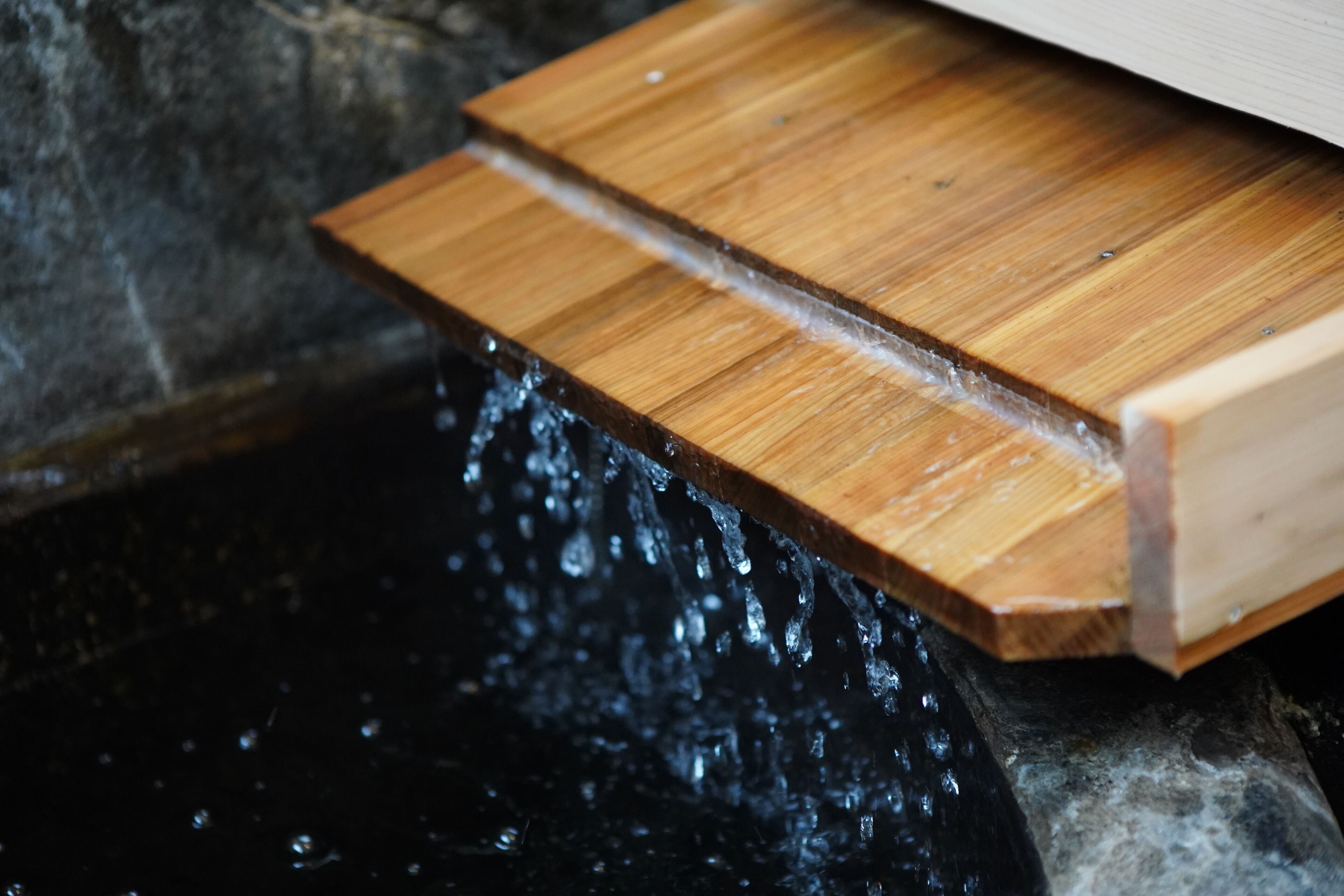 A wooden structure with water flowing over it.