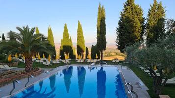 Seasonal outdoor pool, open 9:00 AM to 8:00 PM, pool umbrellas