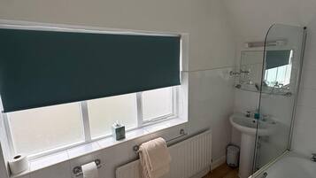 Une salle de bain moderne équipée de toilettes, d’un bidet, d’un lavabo et d’une douche.
