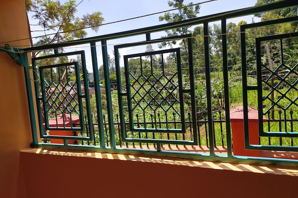Back balcony overlooking a garden, provides fresh air and good site.