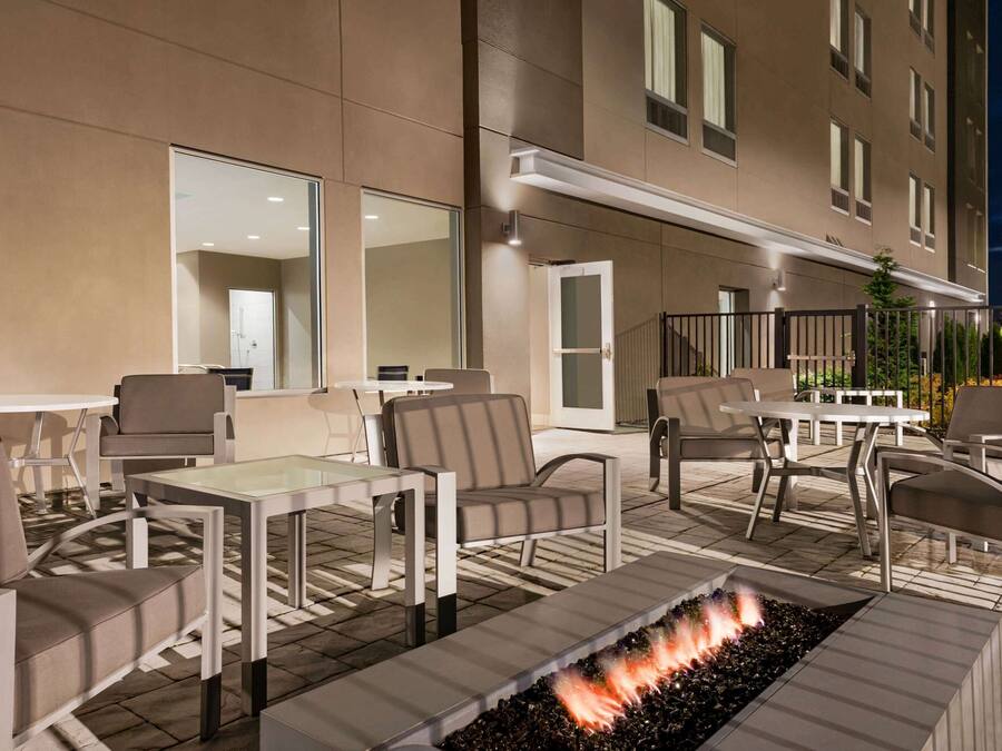 An outdoor patio with seating and a fire feature.