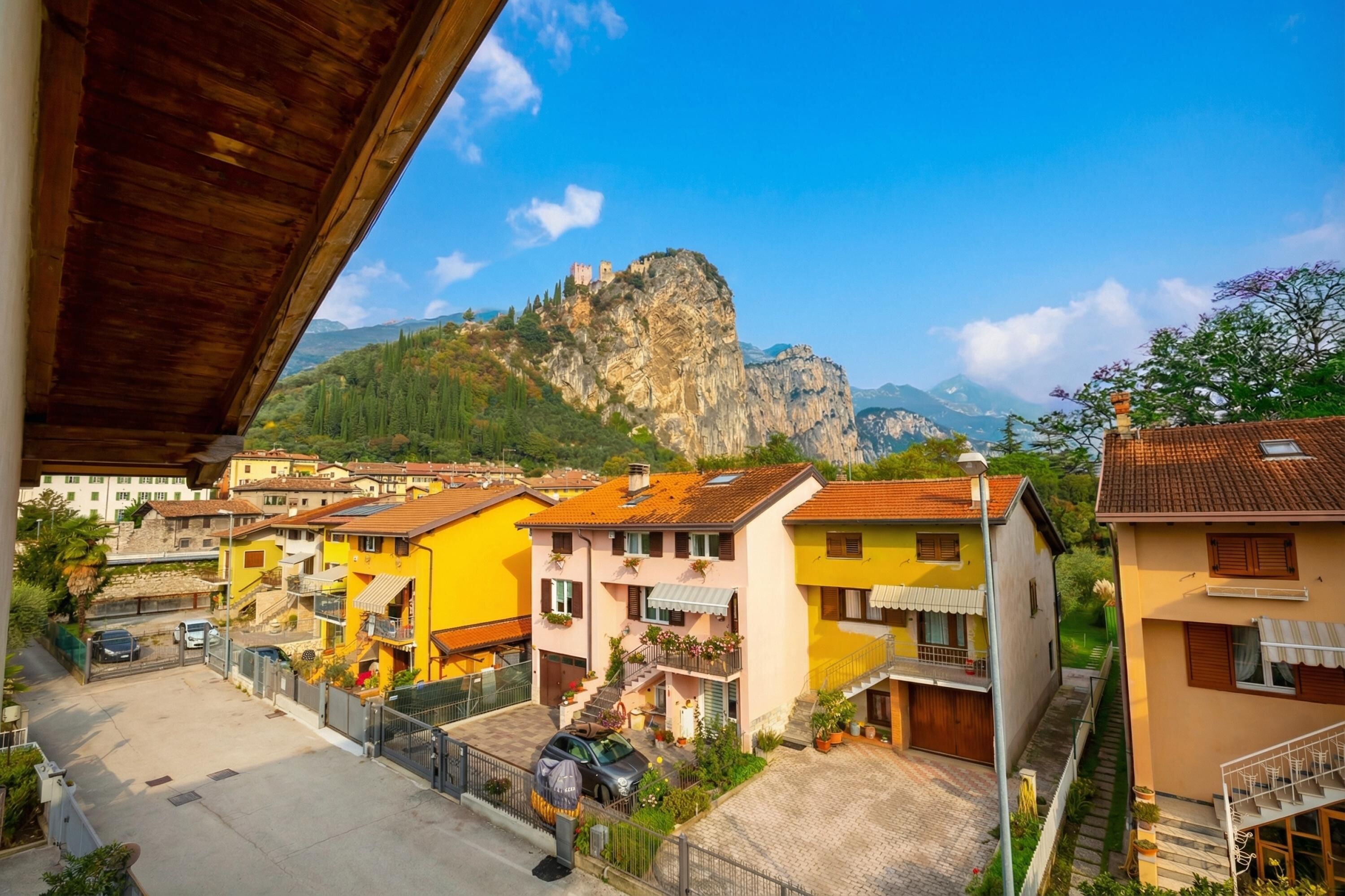 A residential area with colorful buildings, a mountain in the background, and a clear sky.