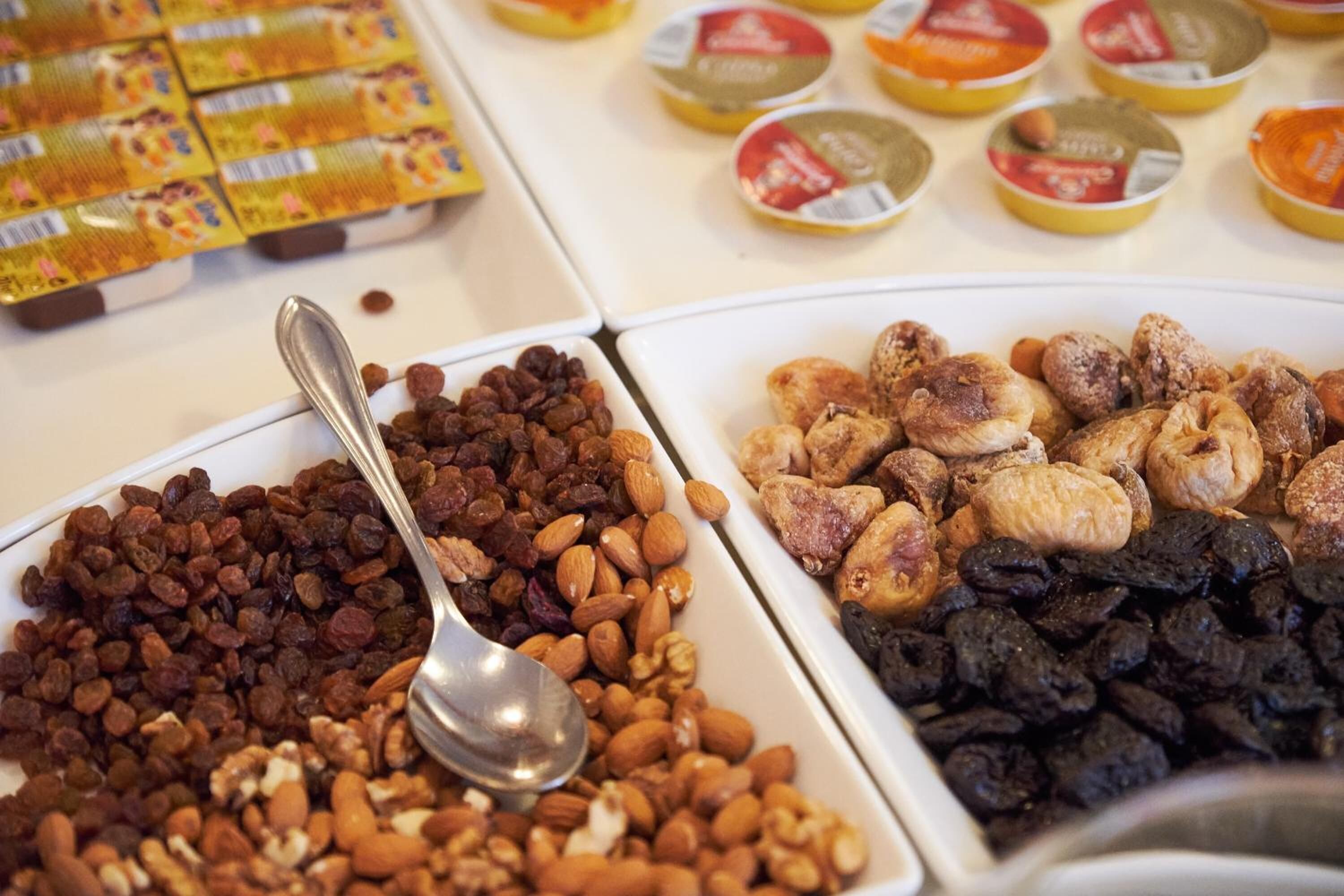 A buffet with various food items including nuts, dried fruits, and packaged snacks.
