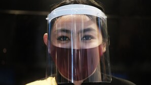 Une personne portant un écran facial.