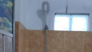 A shower with a handheld showerhead and a wall-mounted faucet. - Abimanyu Homestay (Imogiri)