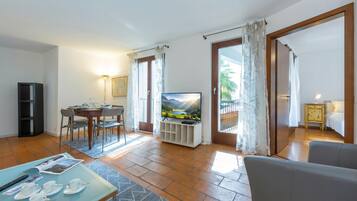 Family Apartment, Multiple Bedrooms (Casa Chiara) | Living area | 22-inch flat-screen TV with cable channels, TV